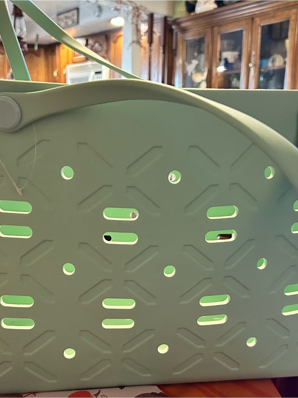 Large green tote bag with cutout pattern